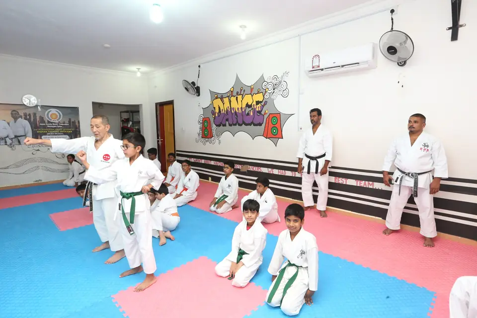 Children practising techniques together on the mat