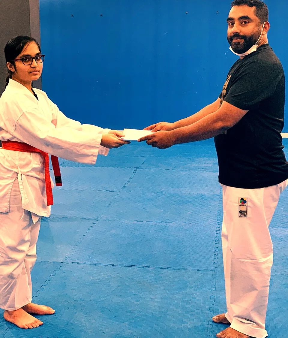 Female student receiving her grading certificate