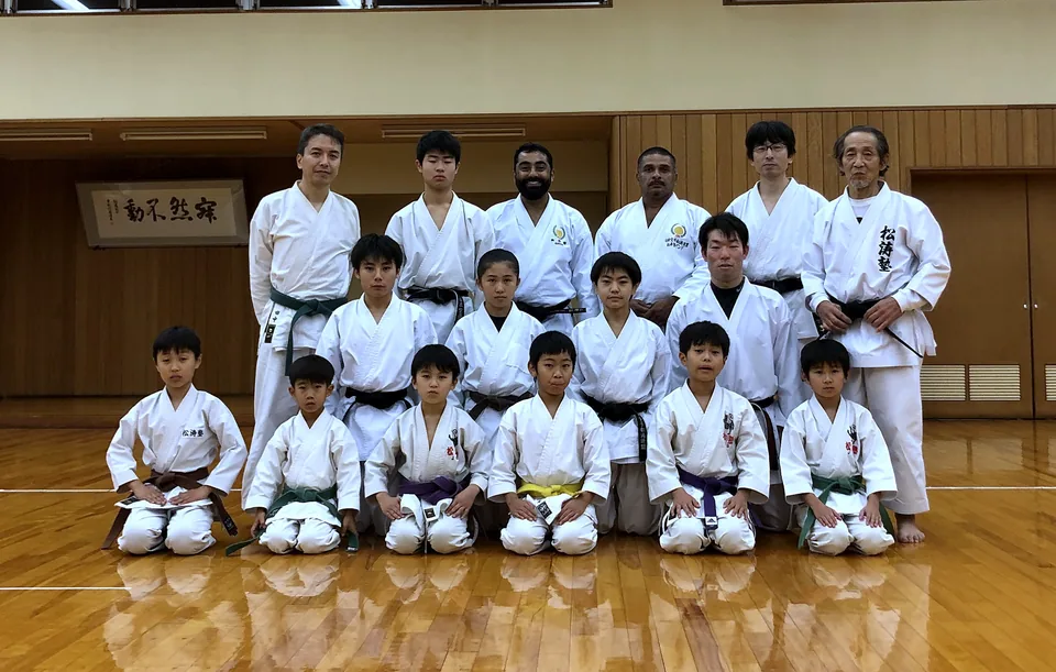 Japanese instructors and young karateka in a dojo in Japan