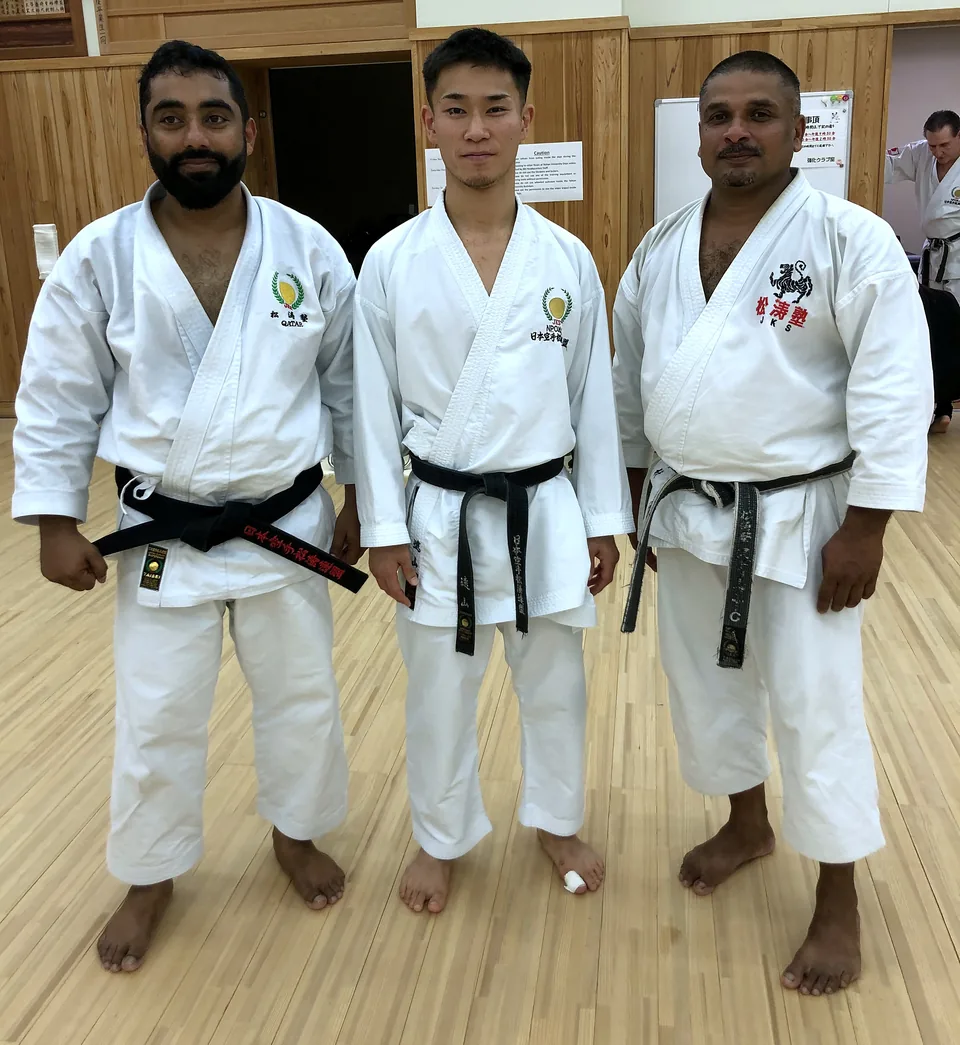 Sensei Najmal with fellow black belts at a dojo in Japan
