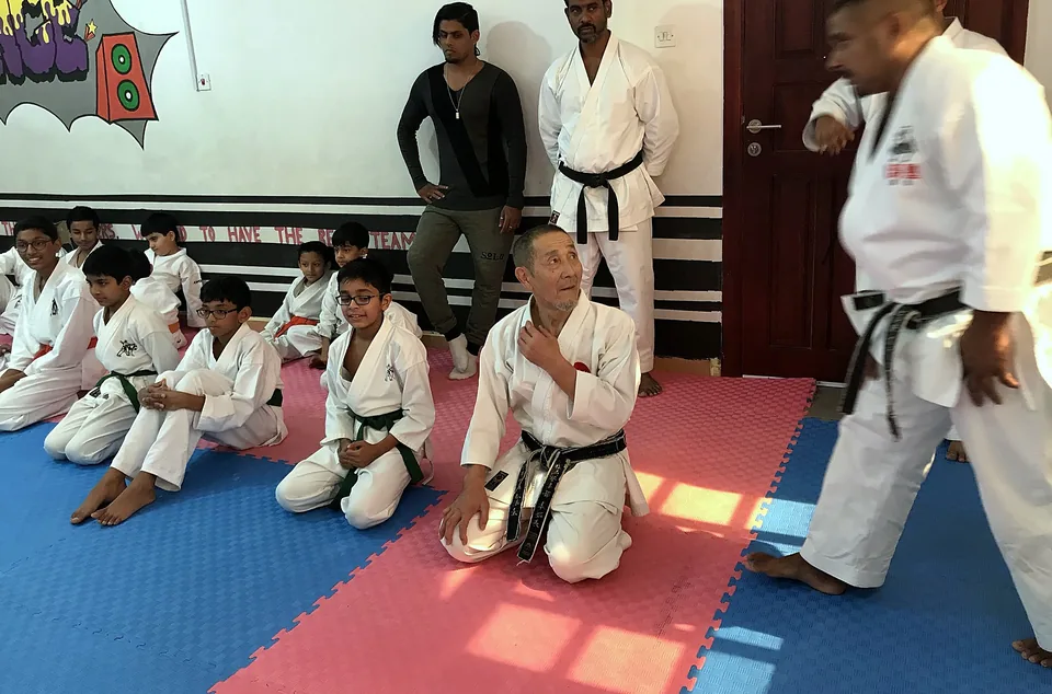A visiting master teaching Chi Club students at a karate seminar in Doha