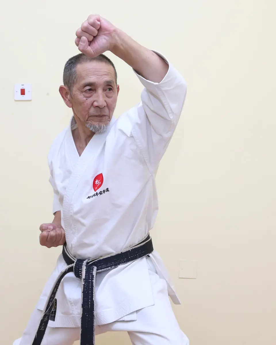 Senior instructor performing a rising block